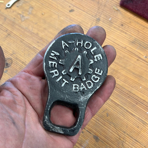 A hole bottle opener with patina