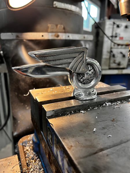 Winged Wheel hood ornament